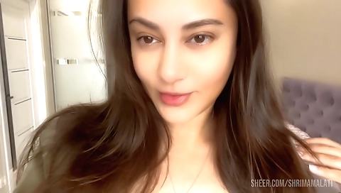 Solo girl with small tits sits on bed to enjoy a hot sex