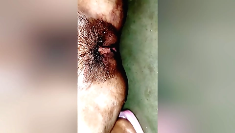 Amateur girl is sucking a dildo in her hairy pussy