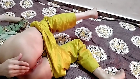 Indian mom plays with her hands while alone in her room