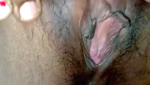 Indian hairy teen is taking a hot crack in her hairy pussy