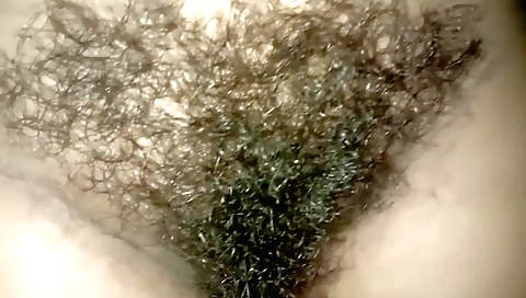 Indian girl with a hairy pussy on top of bed licking